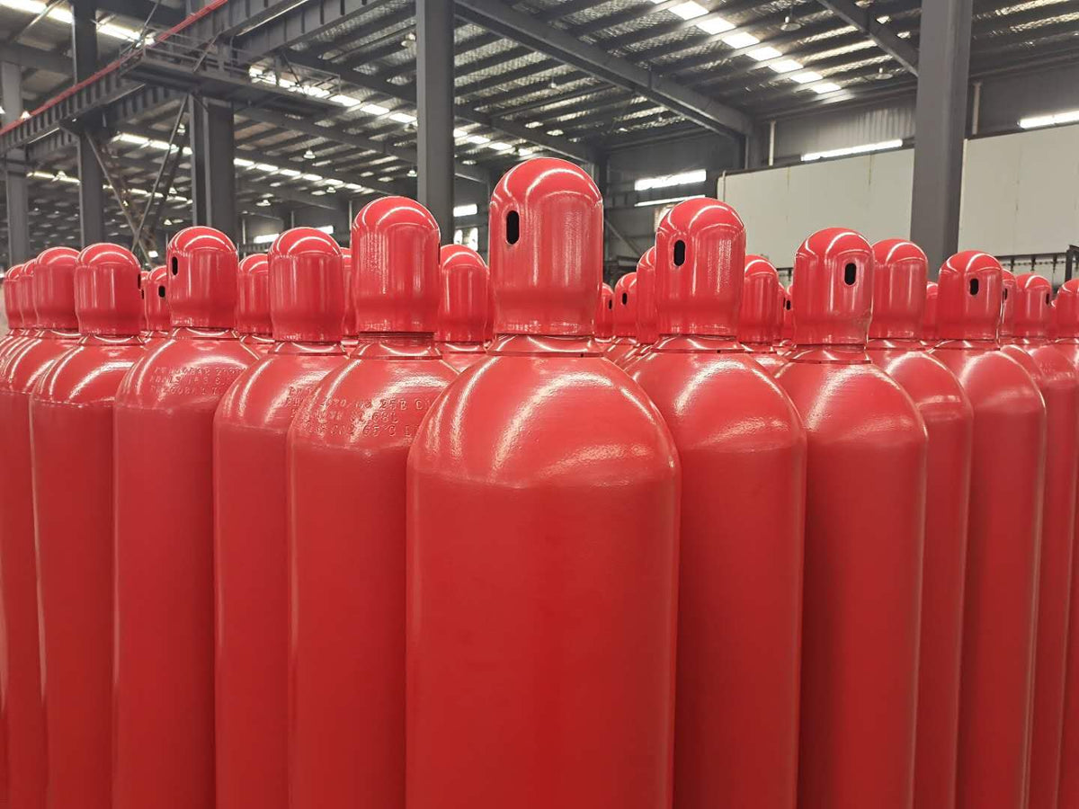 Row of red Carbon Dioxide CO2 cylinders in a warehouse setting
